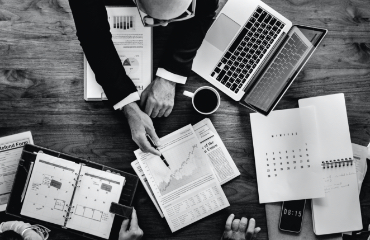 People at a desk showing graphs